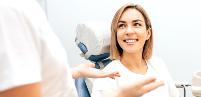 Woman smiling looking at dentist